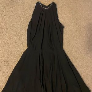 Short black homecoming dress with sequin detailing on the back